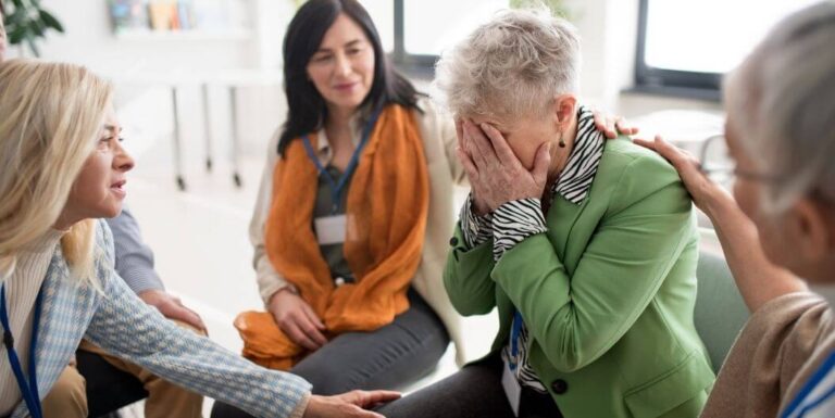 Distressed Elderly Woman in Support Group at Assisted Living Facility